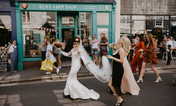 A wedding party dancing down Totnes High Street