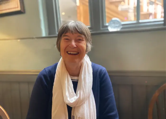 A seated woman smiling